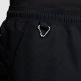 Close-up of black athletic shorts with an elastic waistband and a silver metal carabiner attached near the pocket. - Nike ACG Reservoir Goat Shorts (Men's) - Black/Anthracite/Summit White