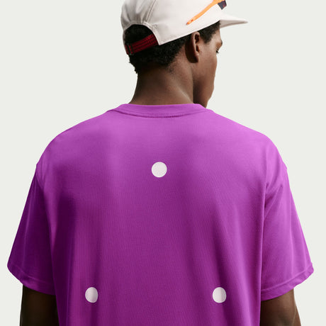 A person shown from the back wearing a bright purple short-sleeve T-shirt with three white circular cutouts or dots on the back, paired with a white cap, against a plain white background. - Nike ACG Dri-FIT T-Shirt (Men's) - Bold Berry/Summit White