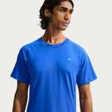 A man wearing a bright blue short-sleeve athletic t-shirt with a small white Adidas logo on the left chest, photographed against a light gray studio background. - Nike ACG Dri-FIT Short-Sleeve Base Layer Top (Men's) - Hyper Royal/Summit White
