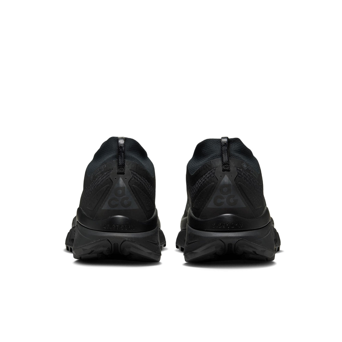 A pair of black athletic sneakers shown from the rear, featuring textured mesh uppers, zip closures, and chunky black midsoles on a solid white background. - Nike ACG Zegama Trail GORE-TEX Shoes (Men's) - Black/Anthracite
