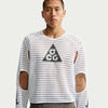 Man wearing a white long-sleeve shirt with a geometric pattern and logo on a plain background - Nike ACG Radical Airflow NXT Dri-FIT Long-Sleeve Trail-Running Top (Men's) - White/Anthracite