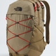 The North Face Balidis backpack in a warm khaki-tan color, featuring prominent red compression straps crisscrossing the front and a black embroidered logo on the upper left. - The North Face Borealis Backpack - Cedar/Lava Red