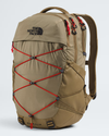 The North Face Balidis backpack in a warm khaki-tan color, featuring prominent red compression straps crisscrossing the front and a black embroidered logo on the upper left. - The North Face Borealis Backpack - Cedar/Lava Red