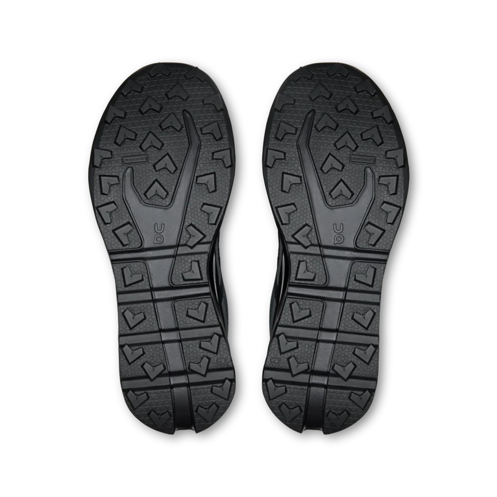 A pair of black athletic shoes shown from the sole view, displaying their textured tread patterns against a plain white background. - On Cloudvista 3 Waterproof Shoes (Men's) - Black