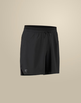 Black athletic shorts with an elastic drawstring waistband and a small white Arc'teryx logo on the lower left hem, shown against a solid beige background. - Arc'teryx Norvan Liner Shorts 7" (Men's) - Black