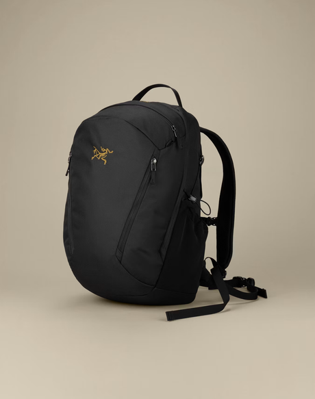 A black Arc'teryx backpack with a small gold logo on the front, shown on a neutral beige background. - Arc'teryx Mantis 26L Backpack - Black