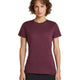 A woman with short brown curly hair wearing a short-sleeve crewneck t-shirt in heathered burgundy, paired with black pants, standing against a solid white background. - Icebreaker Merino 150 Tech Lite Short Sleeve T-Shirt (Women's) - Dark Berry