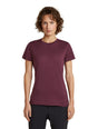 A woman with short brown curly hair wearing a short-sleeve crewneck t-shirt in heathered burgundy, paired with black pants, standing against a solid white background. - Icebreaker Merino 150 Tech Lite Short Sleeve T-Shirt (Women's) - Dark Berry