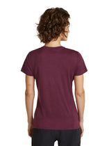 A woman with curly brown hair is shown from the back wearing a short-sleeve crewneck t-shirt in heathered burgundy, paired with black athletic pants, against a plain white background. - Icebreaker Merino 150 Tech Lite Short Sleeve T-Shirt (Women's) - Dark Berry