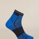 A single athletic ankle sock in blue and dark navy, shown floating against a solid light beige background. The sock features a blue heel and toe, a dark navy compression zone across the instep, and a ribbed navy cuff with the brand name 'Skechers' visible. - Icebreaker Merino Run+ Ultralight Mini Socks (Men's) - Lazurite/Midnight Navy