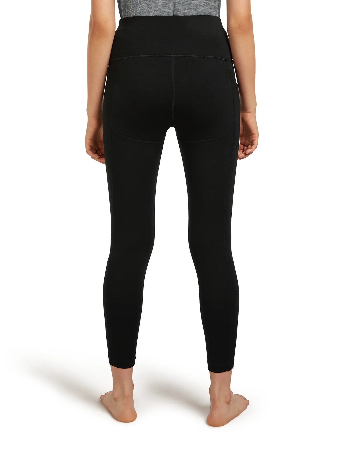 Person wearing black leggings on a white background - Icebreaker Merino 260 Fastray 25" High Rise Tights (Women's) - Black