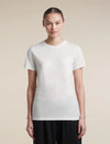A woman modeling a plain white short-sleeve crewneck t-shirt against a solid beige background. - Icebreaker Merino 150 Tech Lite Short Sleeve T-Shirt (Women's) - Ecru Heather