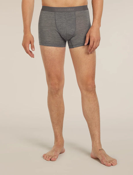 A man wearing heather gray boxer briefs with a dark gray waistband featuring the 'lebrecher' brand logo, shown from the waist down against a light beige studio background. - Icebreaker Merino Blend 125 Cool-Lite Anatomica Boxers (Men's) - Gritstone Heather