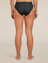 Rear view of a model wearing black Icebreaker briefs against a light beige studio background. - Icebreaker Merino Blend 125 Cool-Lite Sprite Hipster (Women's) - Black