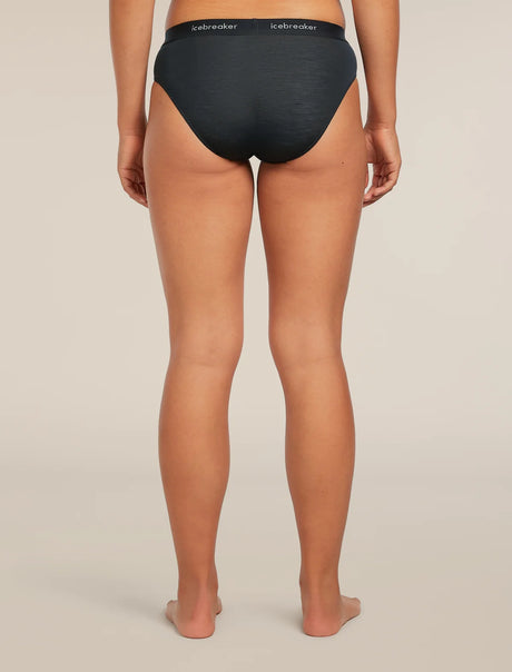 Rear view of a model wearing black Icebreaker briefs against a light beige studio background. - Icebreaker Merino Blend 125 Cool-Lite Sprite Hipster (Women's) - Black
