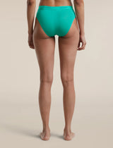 A model shown from the back wearing bright turquoise high-waisted underwear against a solid beige studio background. - Icebreaker Merino Blend 125 Cool-Lite Sprite Hipster (Women's) - Fresh
