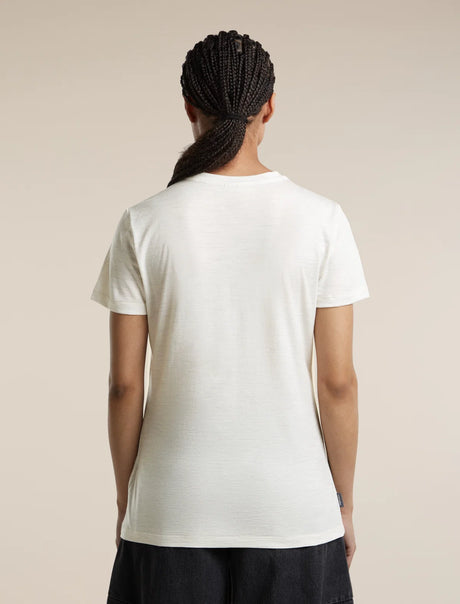 A person shown from the back wearing a plain white short-sleeve crew-neck T-shirt and dark bottoms, standing against a light beige studio background. - Icebreaker Merino 150 Tech Lite Short Sleeve T-Shirt Sparkling Stars (Women's) - Ecru Heather