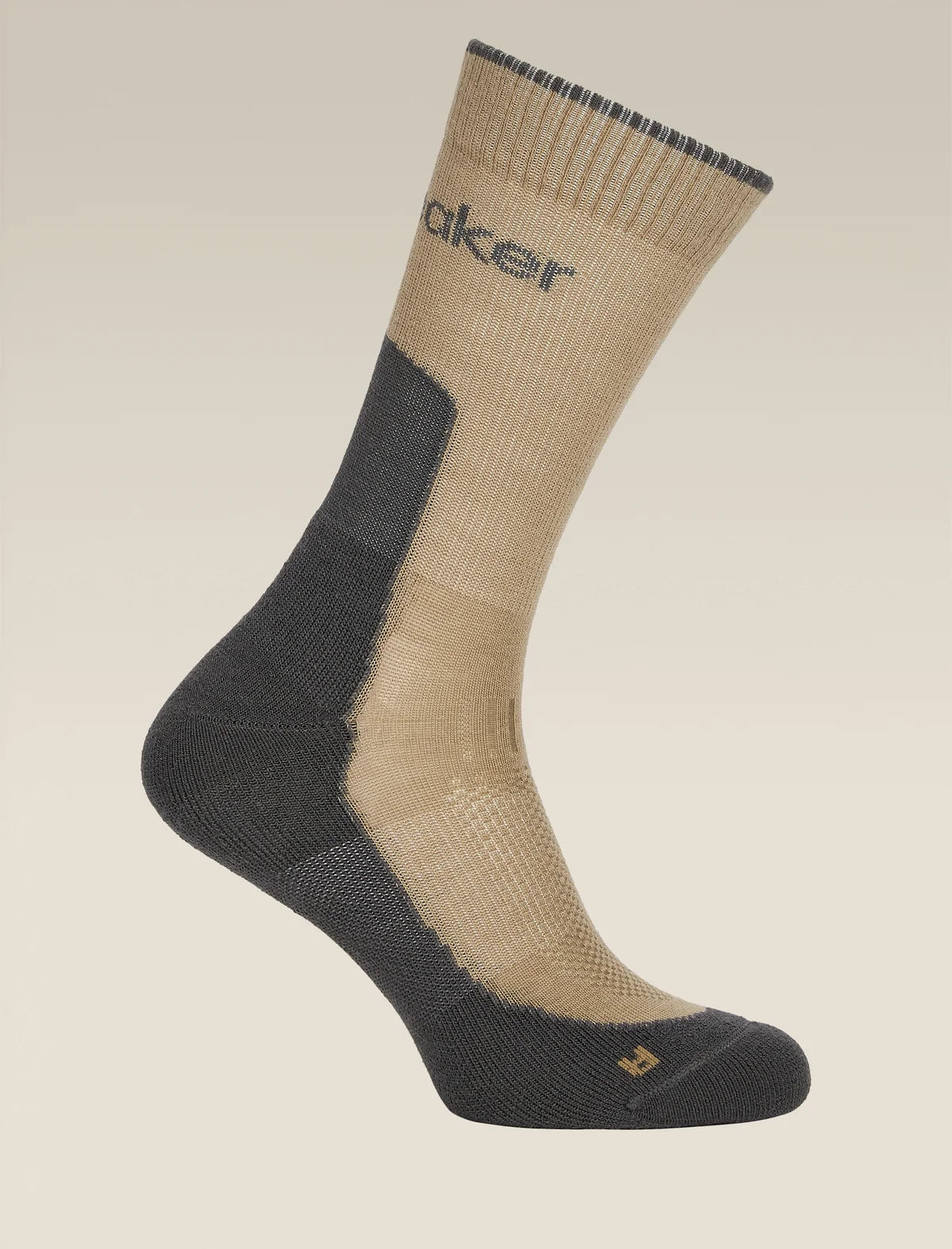 A single mid-calf athletic sock shown on a clean, light beige background. The sock features a beige upper section and a dark gray lower section with a textured knit pattern. - Icebreaker Merino Hike+ Light Crew Socks (Men's) - Cumin/Obsidian