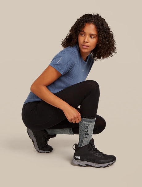 Woman in athletic wear posing on a beige background - Icebreaker Merino Hike+ Mountaineer Mid Calf Socks (Women's) - Jet Heather/Black