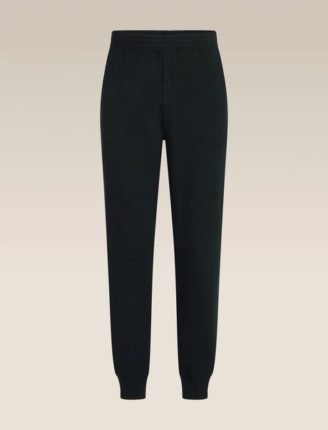 Black jogger sweatpants with an elastic waistband and ribbed ankle cuffs, shown against a light beige gradient background. - Icebreaker Merino Blend 150 Drift Pants (Men's) - Black