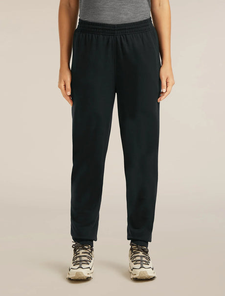 Person wearing black pants on a beige background - Icebreaker Merino Blend 150 Drift Pants (Women's) - Black