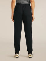 Person wearing black pants on a beige background - Icebreaker Merino Blend 150 Drift Pants (Women's) - Black