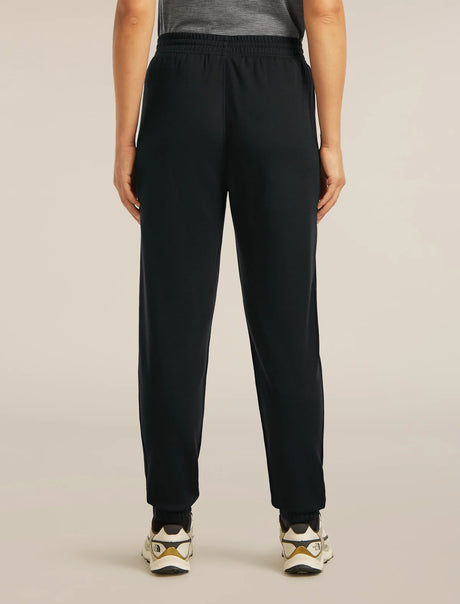 Person wearing black pants on a beige background - Icebreaker Merino Blend 150 Drift Pants (Women's) - Black