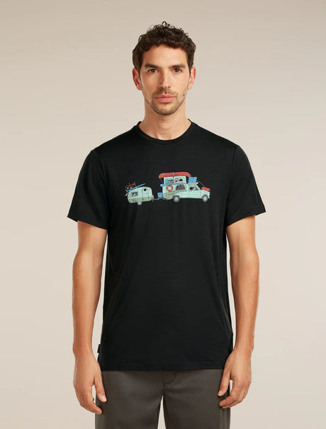 Man wearing a black t-shirt with a graphic design on a beige background - Icebreaker Merino 150 Tech Lite Short Sleeve T-Shirt Transportage (Men's) - Black