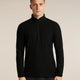 A man wearing a black long-sleeve quarter-zip athletic pullover with a textured waffle knit pattern, standing against a solid light beige background. - Icebreaker Merino 400 RealFleece Grid Peaksland Long Sleeve Half Zip (Men's) - Black