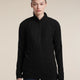 A woman modeling a black long-sleeve quarter-zip athletic pullover against a solid beige studio background. - Icebreaker Merino 400 RealFleece Grid Peaksland Long Sleeve Half Zip (Women's) - Black