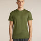 A man wearing an olive green athletic t-shirt with a subtle mountain line-art graphic near the hem, paired with dark gray athletic pants, standing against a solid beige background. - Icebreaker Merino 150 Tech Lite Short Sleeve T-Shirt 3D Mapping (Men's) - Sphagnum