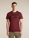 A man wearing a short-sleeve crewneck t-shirt in maroon with a dark horizontal stripe pattern across the chest, paired with khaki pants, against a solid beige background. - Icebreaker Merino 150 Tech Lite Short Sleeve T-Shirt Getaway (Men's) - Port