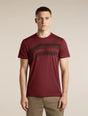 A man wearing a short-sleeve crewneck t-shirt in maroon with a dark horizontal stripe pattern across the chest, paired with khaki pants, against a solid beige background. - Icebreaker Merino 150 Tech Lite Short Sleeve T-Shirt Getaway (Men's) - Port