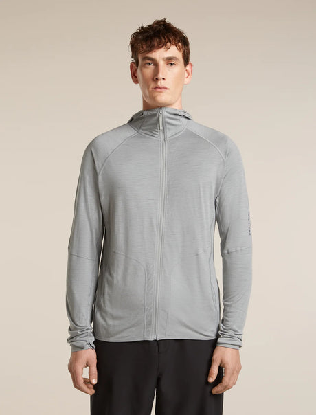 Man wearing a gray jacket on a beige background - Icebreaker 150 MerinoFine Ace Long Sleeve Zip Hoodie (Men's) - Proto Grey