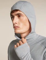 Man wearing a gray hooded outfit against a beige background - Icebreaker 150 MerinoFine Ace Long Sleeve Zip Hoodie (Men's) - Proto Grey