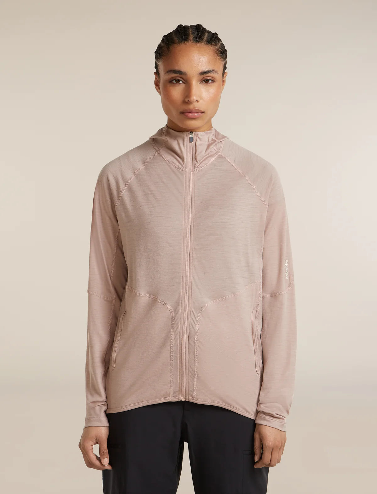 Person wearing a light pink zip-up jacket on a beige background - Icebreaker 150 MerinoFine Ace Long Sleeve Zip Hoodie (Women's) - Pink Quartz