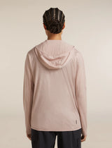 A person shown from the back wearing a light blush pink hooded long-sleeve athletic top and dark pants, photographed against a plain warm off-white studio background. - Icebreaker 150 MerinoFine Ace Long Sleeve Zip Hoodie (Women's) - Pink Quartz
