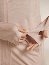 Close-up of a person wearing a beige zip-up jacket, focusing on the texture and fit. - Icebreaker 150 MerinoFine Ace Long Sleeve Zip Hoodie (Women's) - Pink Quartz