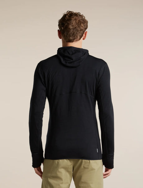 A man viewed from behind wearing a black long-sleeve hooded pullover top and khaki pants, standing against a plain beige studio background. - Icebreaker Merino Blend 200 RealFleece Descender Long Sleeve Zip Hoodie (Men's) - Black