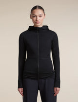 A woman modeling a black long-sleeve athletic zip-up hoodie with a hood, shown against a plain beige studio background. - Icebreaker Merino Blend 200 RealFleece Descender Long Sleeve Zip Hoodie (Women's) - Black