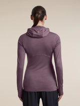 A woman viewed from the back wearing a long-sleeve hooded athletic top in a muted mauve-purple color, paired with dark pants, against a plain beige studio background. - Icebreaker Merino Blend 200 RealFleece Descender Long Sleeve Zip Hoodie (Women's) - Grey Plum - Purple