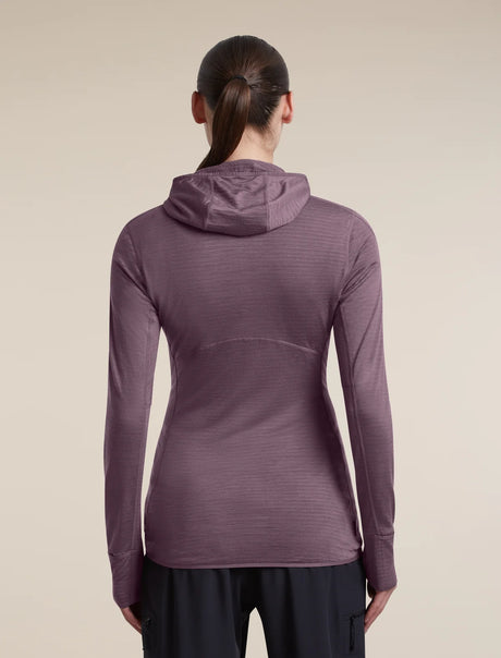 A woman viewed from the back wearing a long-sleeve hooded athletic top in a muted mauve-purple color, paired with dark pants, against a plain beige studio background. - Icebreaker Merino Blend 200 RealFleece Descender Long Sleeve Zip Hoodie (Women's) - Grey Plum - Purple