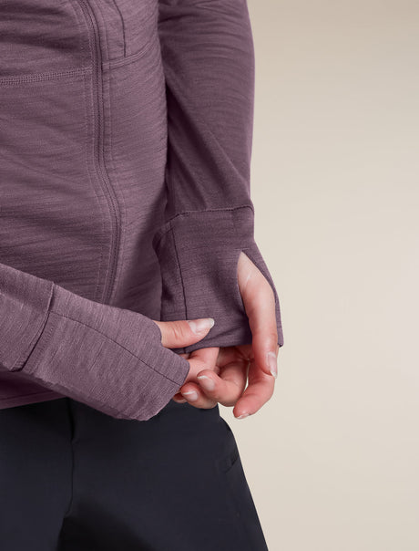 Close-up of a person wearing a textured, long-sleeve athletic top in a muted plum-purple color, showing the fabric detail and cuff construction. - Icebreaker Merino Blend 200 RealFleece Descender Long Sleeve Zip Hoodie (Women's) - Grey Plum - Purple