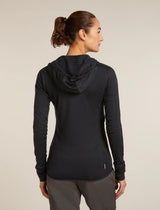 A woman shown from the back wearing a black long-sleeve athletic hooded top and gray pants against a plain light beige studio background. - Icebreaker Merino Blend 300 RealFleece Descender Long Sleeve Zip Hoodie (Women's) - Black
