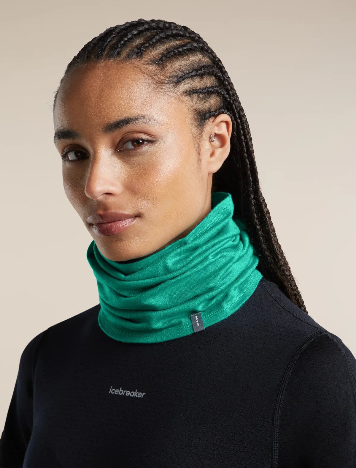 A close-up of a woman wearing a bright green athletic neck gaiter over a black long-sleeve top. The neck gaiter is ruched and fitted, with a small dark brand tag on the side. - Icebreaker Merino 200 Flexi Chute (Unisex) - Fresh