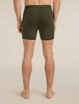 Person wearing olive green boxer briefs on a beige background - Icebreaker Merino 150 Anatomica Boxers (Men's) - Dark Loden