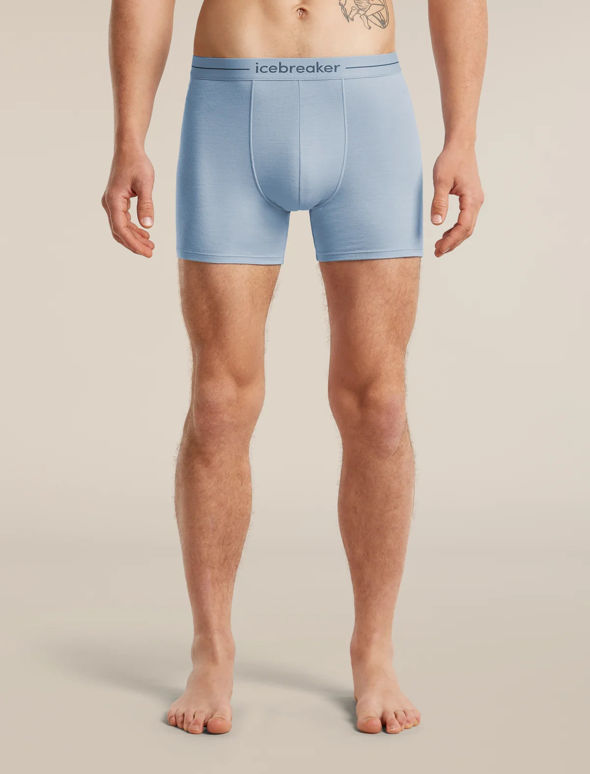 A man wearing light blue Icebreaker boxer briefs, shown from the waist down against a plain beige studio background. - Icebreaker Merino 150 Anatomica Boxers (Men's) - Zinc Blue