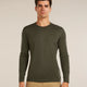Man wearing a green long-sleeve shirt against a beige background - Icebreaker Merino 200 Oasis Long Sleeve Crew Thermal Top (Men's) - Dark Loden