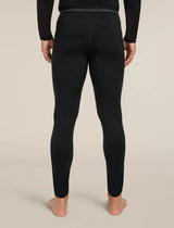 Person wearing black leggings on a beige background - Icebreaker Merino 200 Oasis Thermal Leggings (Men's) - Black