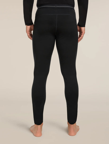 Person wearing black leggings on a beige background - Icebreaker Merino 200 Oasis Thermal Leggings (Men's) - Black